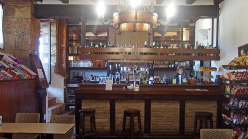 a bar in a restaurant with stools at Posada de Roncesvalles in Roncesvalles