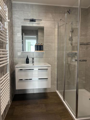a bathroom with a sink and a shower at PlatanHome 12 in Lenti