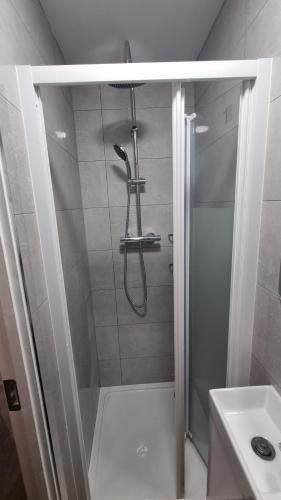 a bathroom with a shower and a sink at Cosy Condo near City & Airport in Dublin