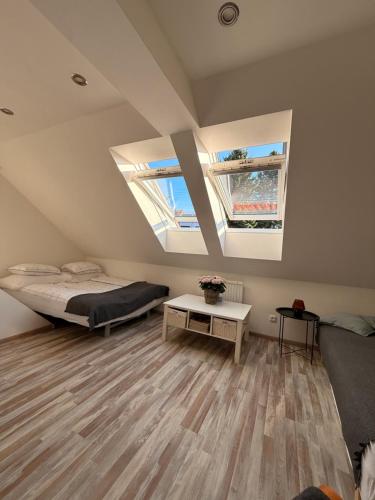 a bedroom with a bed and two windows at Apartmán Bílé Karpaty in Strání