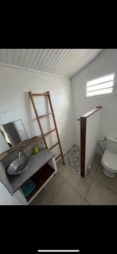 a bathroom with a sink and a toilet at Les Chambres d'Umoja in Grand-Bourg