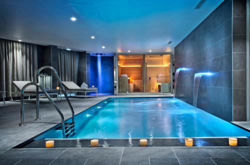 a swimming pool in a hotel room at Golden Tulip Sophia Antipolis - Hotel & Spa in Valbonne