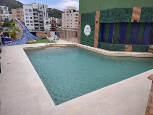 a swimming pool on the side of a building at Hotel Obelisco in Cali