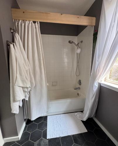 a bathroom with a shower and a bath tub at Quaint & Vivacious Room-Queen in Kyle