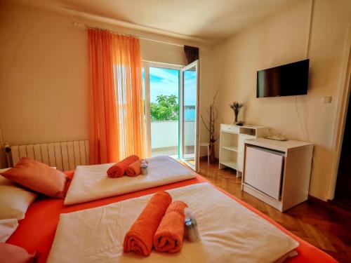 a hotel room with two beds with towels on them at Room`s Brica in Barbat na Rabu