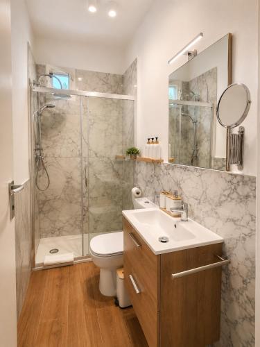 a bathroom with a sink and a shower and a toilet at Casa Camelia Mare in Viareggio