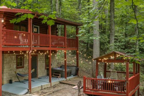 a tree house in the woods with a grill at Re-Up Retreat King Bed, Hot Tub, Zero Pet Fees in Whittier