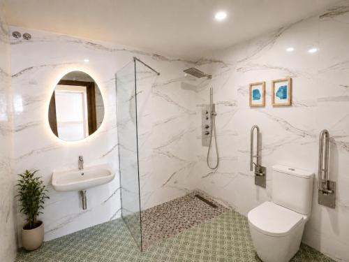 a white bathroom with a sink and a toilet at 10ToSea Premium Hostal in Fuengirola