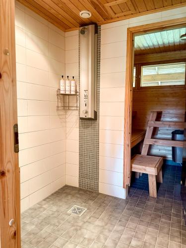 a shower with a bench in a room at Silver Lodge in Luosto