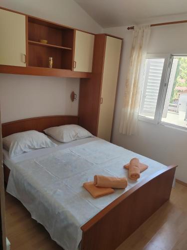 a bedroom with a bed with two towels on it at Apartmani Ferri 2 in Vrbanj