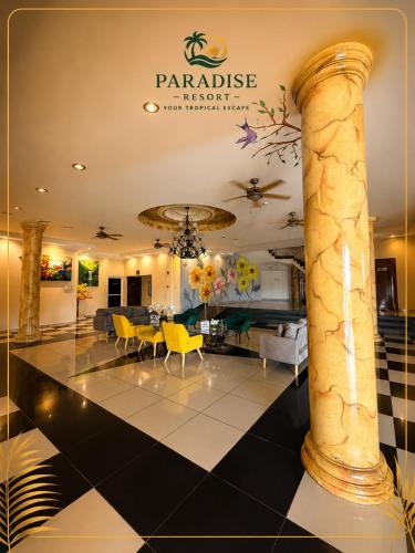 a lobby with a table and chairs and a pillar at Paradise Resort in Los Santos