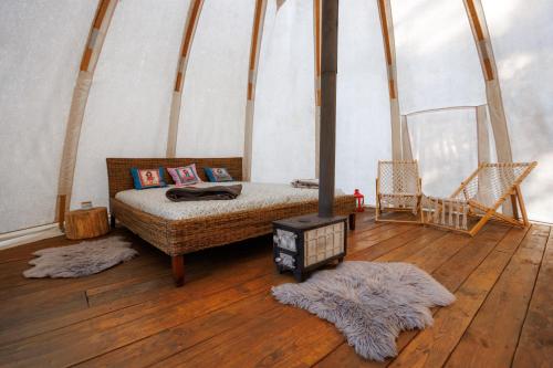 a bedroom with a bed in a tent at glamping podtrosky in Troskovice