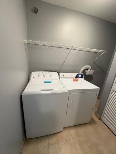 a white washer and dryer in a room at Villas at Fortune Place in Kissimmee