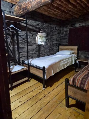 a bedroom with two bunk beds in a log cabin at Hotel Front Castle in Shatili