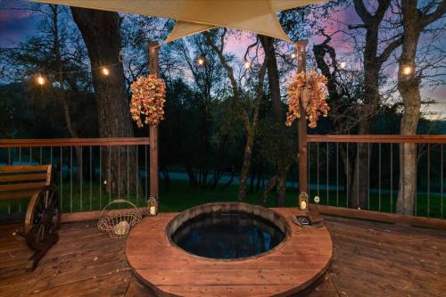 a wooden jacuzzi tub on a wooden deck at Halfling House w/hot tub/firepit/more! in Coarsegold