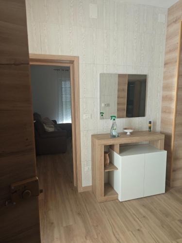 a living room with a mirror and a white cabinet at locazione turistica da Iole in Popoli