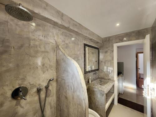 a bathroom with a shower and a sink at Mihal Suites in Sarandë