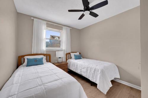 a bedroom with two beds and a ceiling fan at Between Tides 2BR Walk to Beach Unit B in Seaside Park