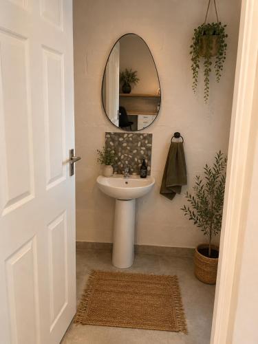 a bathroom with a sink and a mirror at The Cabernet Cottage - One Bedroom in Table View