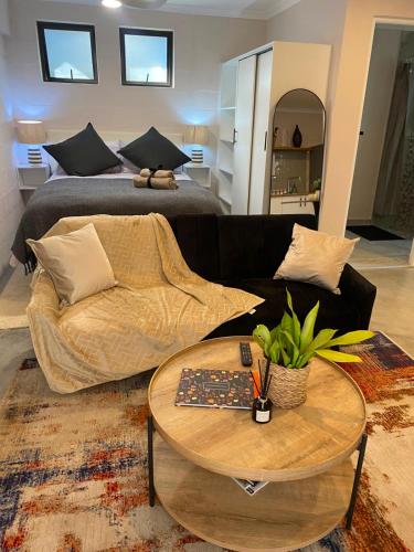 a living room with a couch and a table at The Cabernet Cottage - One Bedroom in Table View
