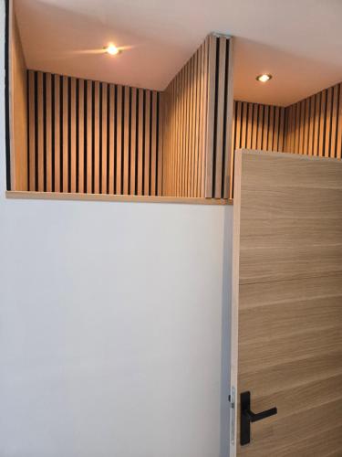 a room with a wooden wall and a door at small and cozy in Perpignan
