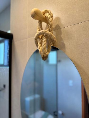 a piece of rope with a mushroom on a wall at Studio Patacho Rota dos Milagres in Pôrto de Pedras
