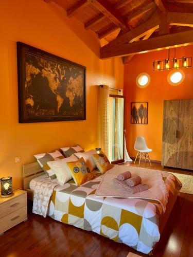 a bedroom with a large bed with a map on the wall at Le Domaine d'Adrien in Larnage