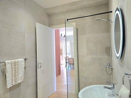 a bathroom with a sink and a glass shower at Azure Garden Villa 317 in Lalzit Bay