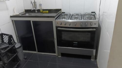 a kitchen with a stove and a sink at Casa da Floresta in Vitória