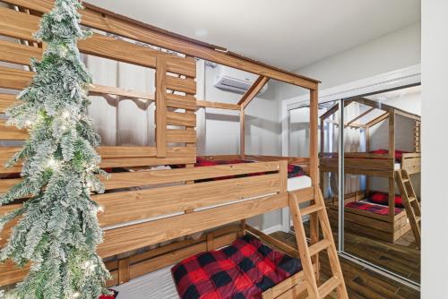 a room with bunk beds and a christmas tree at Cozy Corner in East Stroudsburg