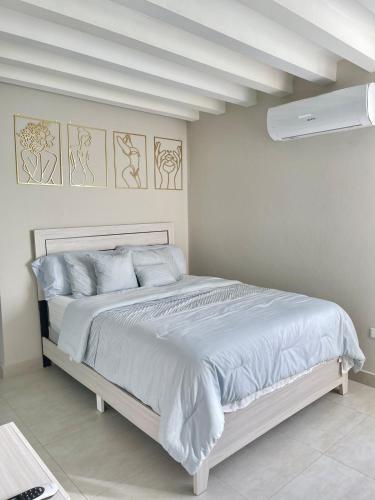 a white bedroom with a large bed in it at Modern 4BR Oasis in Bayamón
