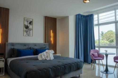 a bedroom with a large bed and a table and chairs at PGD Blue city view in Rawai Beach