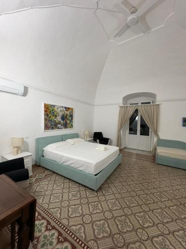 a large bedroom with a bed and a table at Dallatorre B&B in Lizzano