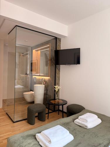 a bathroom with a toilet and a glass wall at Kamea in Poznań