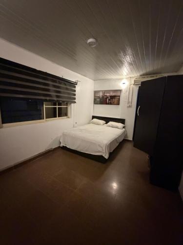 a small bedroom with a bed and a window at Epa's Place in Awoyaya