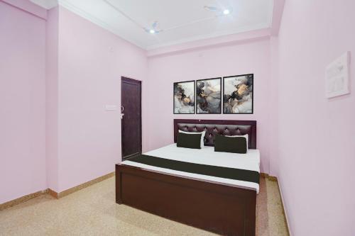 a bedroom with a bed in a white room at Hotel O Relax Inn in Lucknow