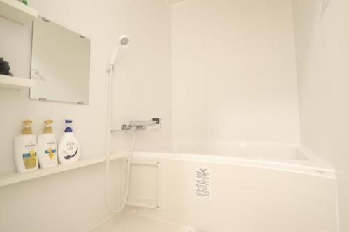 a white bathroom with a sink and a shower at AZ HOTEL - Vacation STAY 56046v in Sumoto