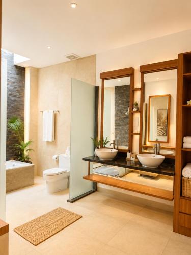 a bathroom with two sinks and a mirror at Asania Villa in Uluwatu