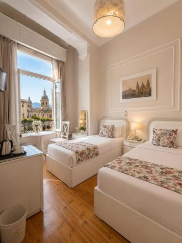 a hotel room with two beds and a window at new colmbia in Cairo