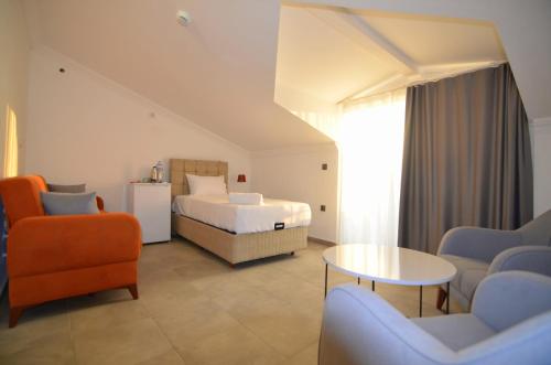a bedroom with a bed and a table and chairs at Fethiye Cagri Pansiyon in Fethiye