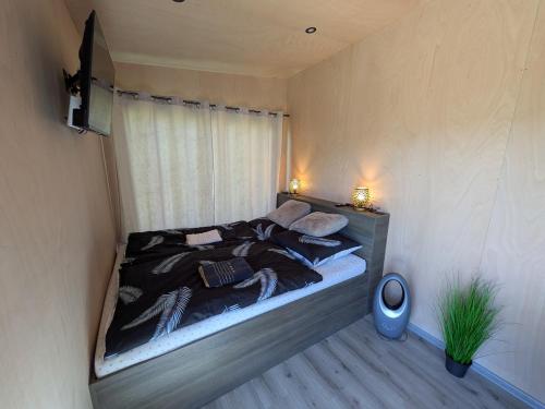 a bedroom with a large bed in a room at Tiny House Dedinky in Dedinky