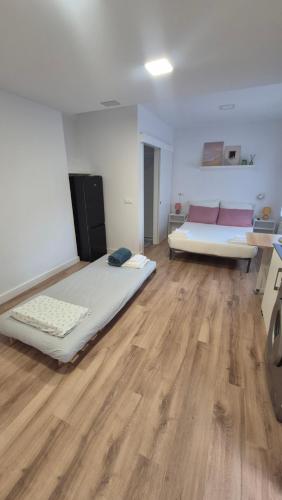 a room with two beds and a couch in it at Casa Adrianykenia in San Martín de Laspra