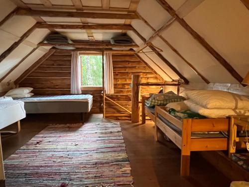a room with two beds and a window at Järvenukka Puhkemaja in Ähijärve