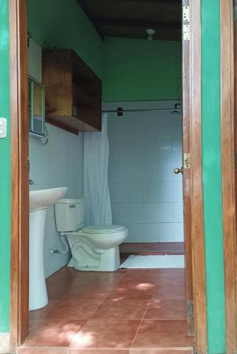 a bathroom with a toilet and a sink at Beach-Front Bungalow in El Gigante