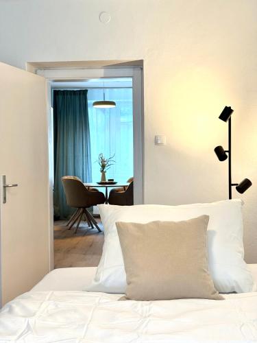 a bedroom with a bed with a view of a table at Mountain Nest Apartment in Schottwien