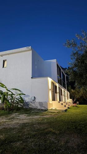 a white building with graffiti on the side of it at Escape Suites in Dhërmi