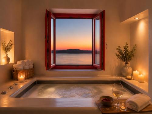 a bath tub with a window with a view of the ocean at Mamma Mia Santorini Suites-Volcano -Caldera -Sunset View in Fira
