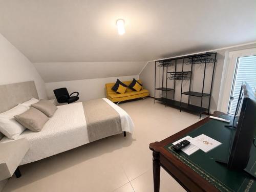 a bedroom with a bed and a desk and a television at Villa Monaco in Mosciano SantʼAngelo
