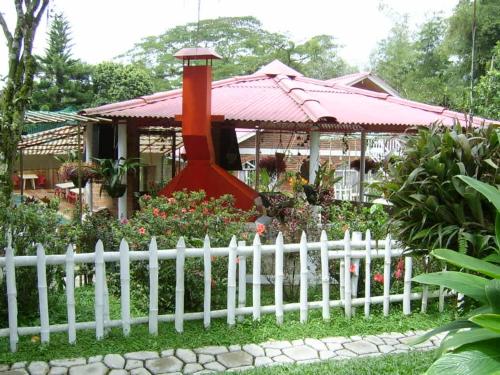 a white fence in front of a house with a gazebo at Touristic House Chalet Luna Verde in Sasaima
