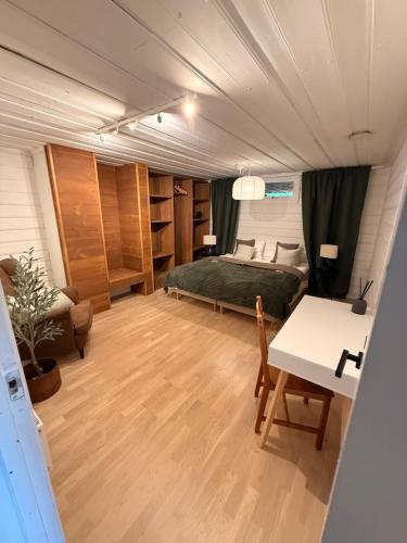 a bedroom with a bed and a desk and a table at Villa Älva i Sälen in Sälen